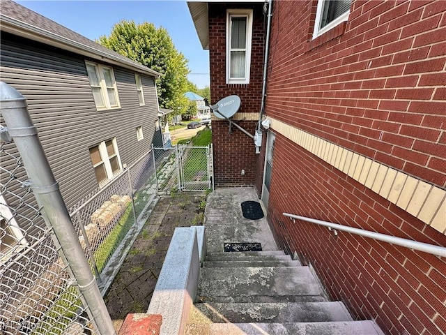 808 Gilbert Ave, Follansbee, WV 26037 - view of side of home featuring brick siding and a gate