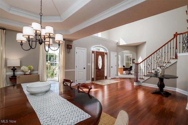 4679 Paxton Rd, Copley, OH 44321 - foyer featuring arched walkways, wood finished floors, a chandelier, stairs, and crown molding