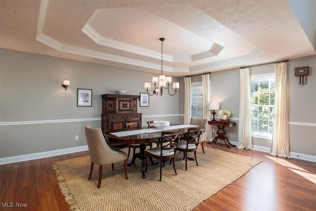 4679 Paxton Rd, Copley, OH 44321 - dining space featuring a raised ceiling, a chandelier, wood finished floors, ornamental molding, and a textured ceiling