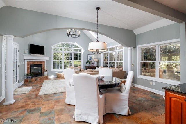 4679 Paxton Rd, Copley, OH 44321 - dining space featuring lofted ceiling, a fireplace, a chandelier, and arched walkways