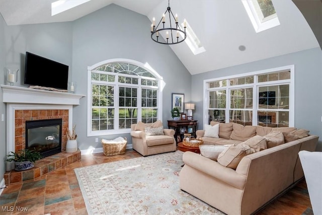 4679 Paxton Rd, Copley, OH 44321 - living room with a skylight, high vaulted ceiling, a chandelier, and a fireplace