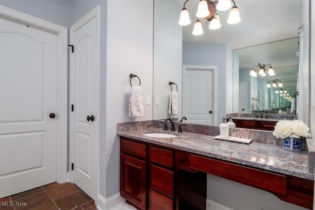 4679 Paxton Rd, Copley, OH 44321 - bathroom featuring a chandelier, vanity, and stone finish flooring