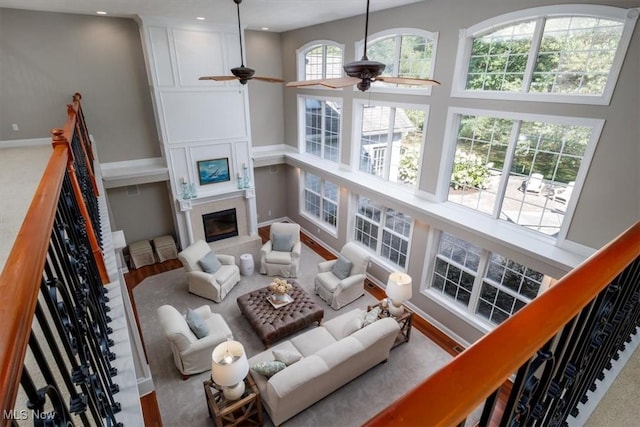 4679 Paxton Rd, Copley, OH 44321 - living room with ceiling fan, a fireplace, a towering ceiling, and recessed lighting