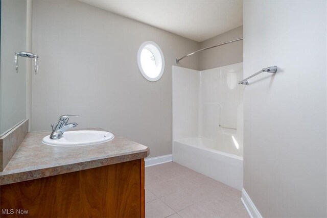 4679 Paxton Rd, Copley, OH 44321 - bathroom with vanity, tile patterned floors, and washtub / shower combination