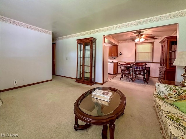 195 Fairlawn Ave, Niles, OH 44446 - living area featuring light carpet, a ceiling fan, and baseboards