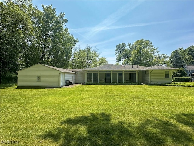 195 Fairlawn Ave, Niles, OH 44446 - back of property with a lawn, a garage, and a sunroom