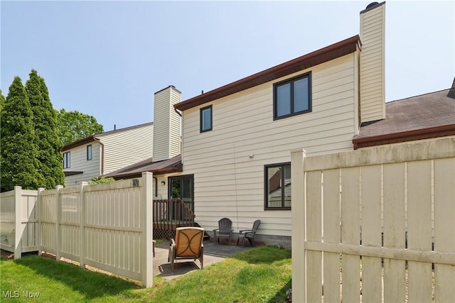 47 Tudor Ln Unit 6C, Kent, OH 44240 - rear view of house with a chimney and a patio