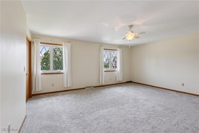 47 Tudor Ln Unit 6C, Kent, OH 44240 - empty room with plenty of natural light, carpet floors, ceiling fan, and baseboards