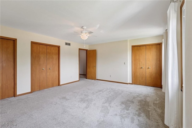 47 Tudor Ln Unit 6C, Kent, OH 44240 - unfurnished bedroom featuring two closets, carpet floors, and baseboards