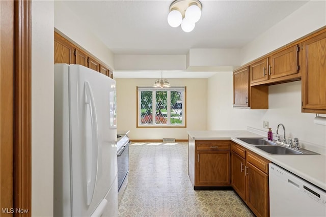 47 Tudor Ln Unit 6C, Kent, OH 44240 - kitchen with white appliances, a sink, a chandelier, and brown cabinets