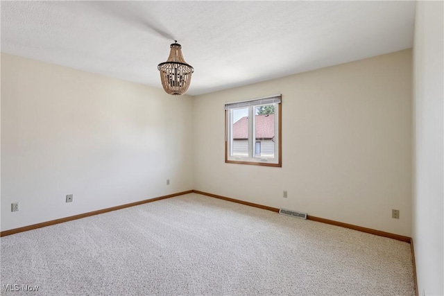 47 Tudor Ln Unit 6C, Kent, OH 44240 - empty room with a chandelier, carpet flooring, and baseboards