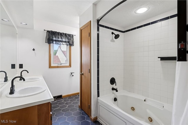 47 Tudor Ln Unit 6C, Kent, OH 44240 - full bathroom featuring a combined bath / shower with jetted tub, double vanity, tile patterned floors, baseboards, and recessed lighting