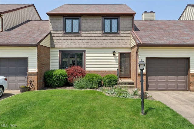 47 Tudor Ln Unit 6C, Kent, OH 44240 - view of front of property with brick siding, a front yard, concrete driveway, and a shingled roof