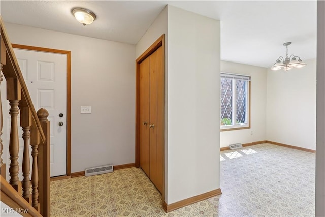 47 Tudor Ln Unit 6C, Kent, OH 44240 - entrance foyer featuring stairs, baseboards, and a chandelier