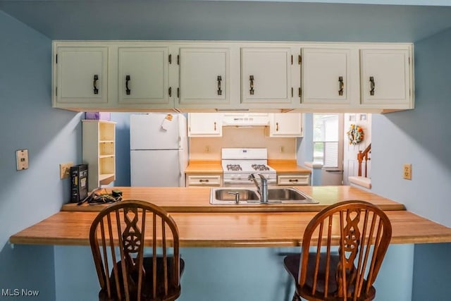 3888 Lake Run Blvd, Stow, OH 44224 - kitchen with white appliances, under cabinet range hood, a sink, and white cabinets