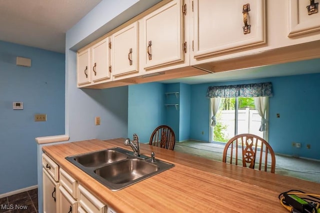 3888 Lake Run Blvd, Stow, OH 44224 - kitchen with a sink, light countertops, white cabinets, and baseboards