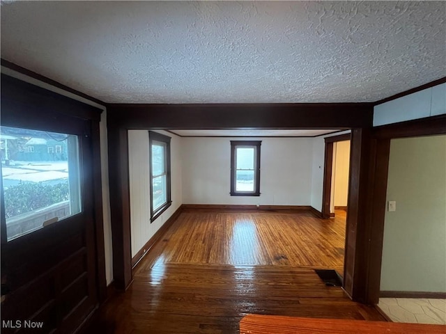 275 Cornell Ave, Amherst, OH 44001 - foyer featuring hardwood / wood-style flooring, baseboards, a textured ceiling, and ornamental molding