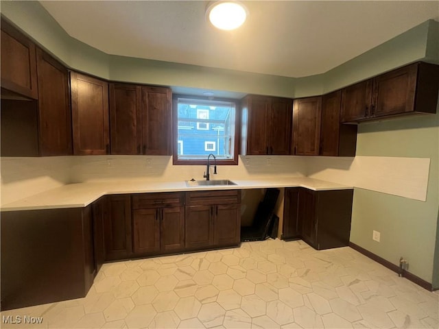 275 Cornell Ave, Amherst, OH 44001 - kitchen featuring a sink, dark brown cabinets, light countertops, and light tile patterned flooring