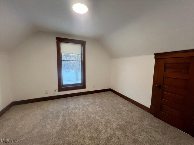 275 Cornell Ave, Amherst, OH 44001 - additional living space featuring carpet floors, vaulted ceiling, and baseboards