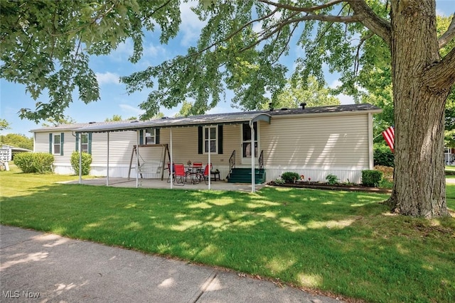 3 Carousel Ln, Olmsted Township, OH 44138 - manufactured / mobile home with a front lawn and a patio area