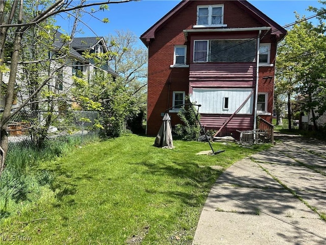 3526 E Blvd, Cleveland, OH 44105 - rear view of house featuring a yard and brick siding