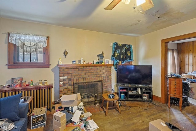 310 N Bentley Ave, Niles, OH 44446 - living area featuring wood finished floors, a brick fireplace, and ceiling fan