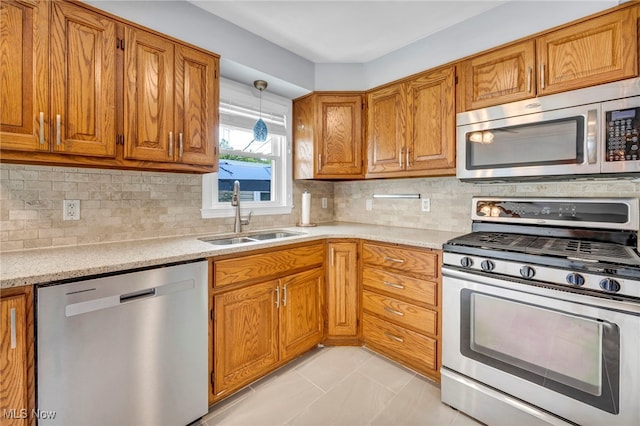 1167 Croyden Rd, Lyndhurst, OH 44124 - kitchen with appliances with stainless steel finishes, a sink, brown cabinetry, and backsplash