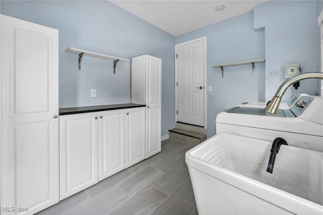 1167 Croyden Rd, Lyndhurst, OH 44124 - laundry room featuring separate washer and dryer and cabinet space
