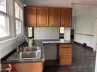 200 Stewart Ave NW, Massillon, OH 44646 - kitchen with a sink, dark countertops, healthy amount of natural light, and brown cabinets