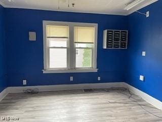 200 Stewart Ave NW, Massillon, OH 44646 - spare room with healthy amount of natural light, wood finished floors, and baseboards