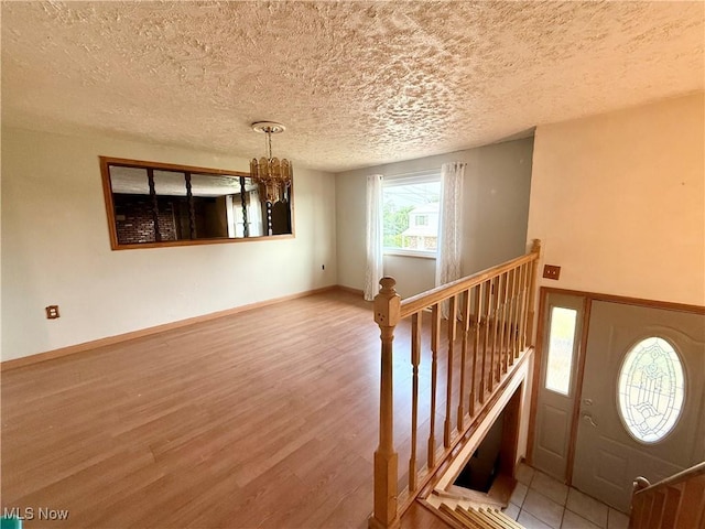 47 Walker Manor Cir, Colliers, WV 26035 - entryway with wood finished floors, a chandelier, and a textured ceiling
