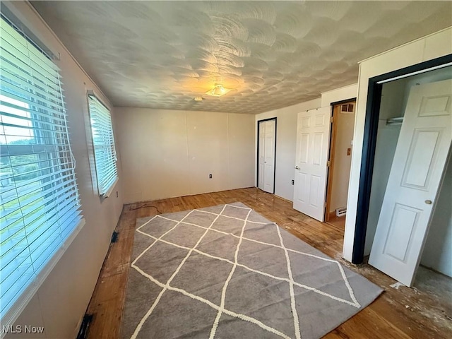 47 Walker Manor Cir, Colliers, WV 26035 - unfurnished bedroom featuring multiple closets and wood finished floors
