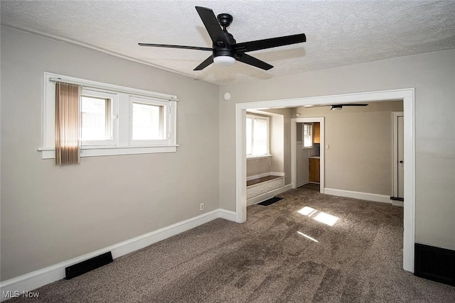 942 Harrison Ave, Akron, OH 44314 - carpeted empty room with ceiling fan, a textured ceiling, and baseboards