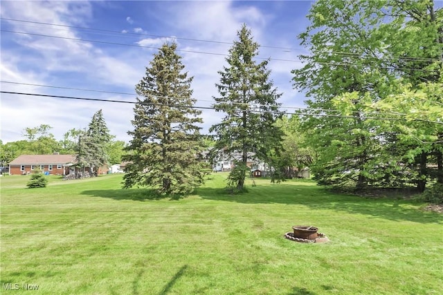 321 Justo Ln, Seven Hills, OH 44131 - view of grassy yard featuring a fire pit
