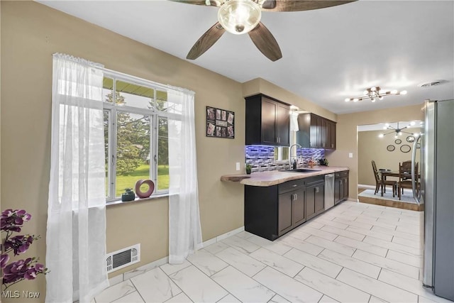 321 Justo Ln, Seven Hills, OH 44131 - kitchen featuring appliances with stainless steel finishes, a sink, light countertops, and baseboards