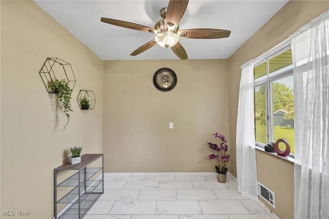 321 Justo Ln, Seven Hills, OH 44131 - doorway to outside with ceiling fan, light marble finish floors, and baseboards