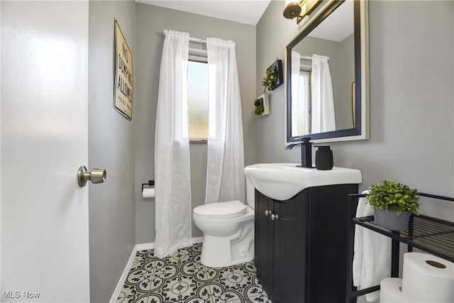 321 Justo Ln, Seven Hills, OH 44131 - bathroom with toilet, vanity, baseboards, and tile patterned floors