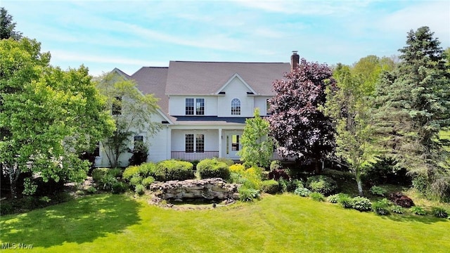 9905 Tudor Pl, Chardon, OH 44024 - view of front facade with a front lawn and a chimney