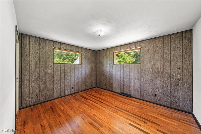 11828 Sheldon Rd, Mantua, OH 44255 - empty room featuring wood-type flooring and wooden walls
