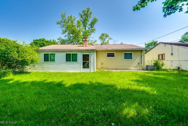 24120 Sherborne Rd, Bedford Heights, OH 44146 - back of house with a chimney and central AC unit