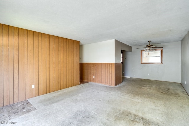24120 Sherborne Rd, Bedford Heights, OH 44146 - unfurnished room featuring wood walls, ceiling fan, carpet floors, and wainscoting