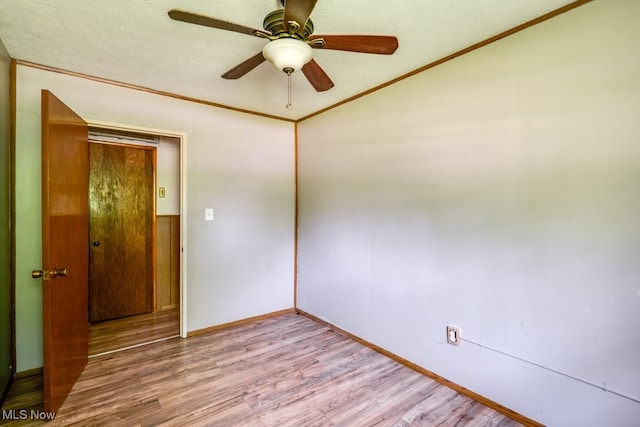 24120 Sherborne Rd, Bedford Heights, OH 44146 - empty room featuring wood finished floors, baseboards, a ceiling fan, crown molding, and vaulted ceiling