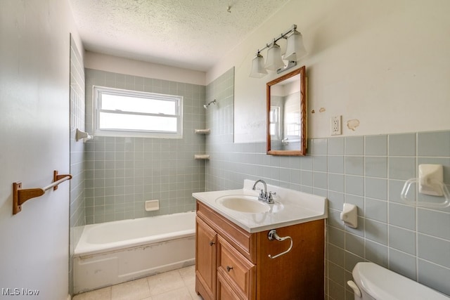 24120 Sherborne Rd, Bedford Heights, OH 44146 - full bath with vanity, toilet, tile walls, washtub / shower combination, and a textured ceiling