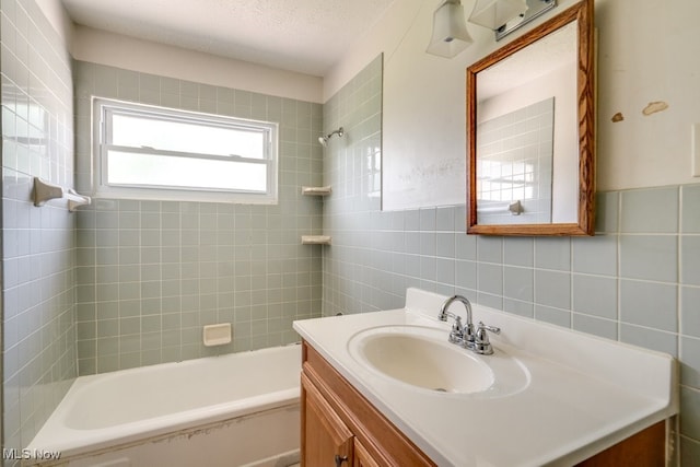 24120 Sherborne Rd, Bedford Heights, OH 44146 - bathroom featuring tile walls, vanity, and tub / shower combination