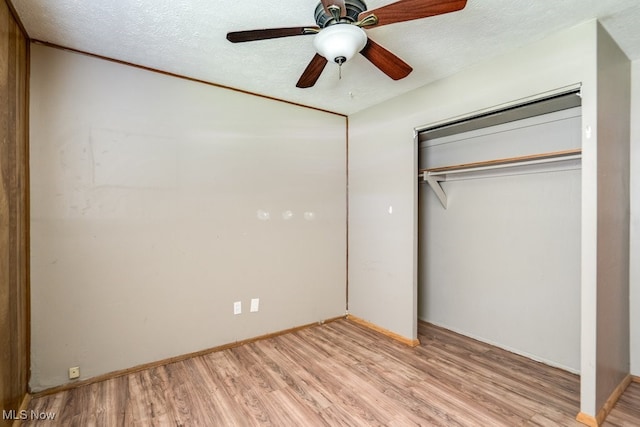 24120 Sherborne Rd, Bedford Heights, OH 44146 - unfurnished bedroom with light wood-style floors, a closet, baseboards, a textured ceiling, and ceiling fan