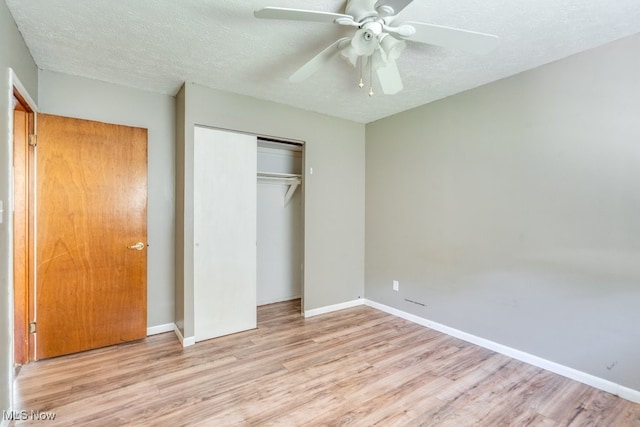 24120 Sherborne Rd, Bedford Heights, OH 44146 - unfurnished bedroom featuring wood finished floors, a closet, a textured ceiling, and baseboards