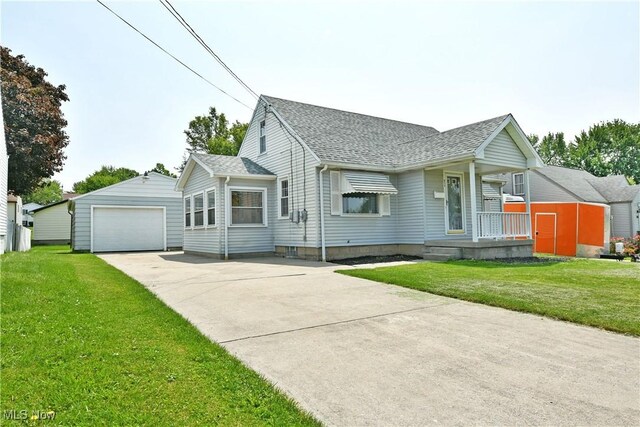 859 Gary Ave, Girard, OH 44420 - view of front of property featuring an outdoor structure, roof with shingles, a detached garage, and a front lawn
