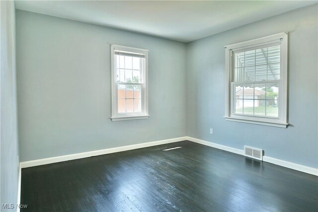 859 Gary Ave, Girard, OH 44420 - unfurnished room with baseboards and dark wood-style flooring