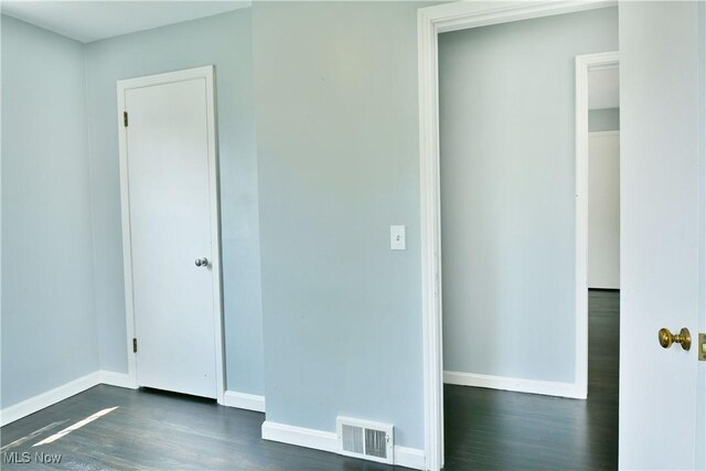 859 Gary Ave, Girard, OH 44420 - unfurnished bedroom with dark wood-style flooring and baseboards