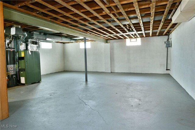 859 Gary Ave, Girard, OH 44420 - basement featuring water heater, gas meter, concrete block wall, and heating unit